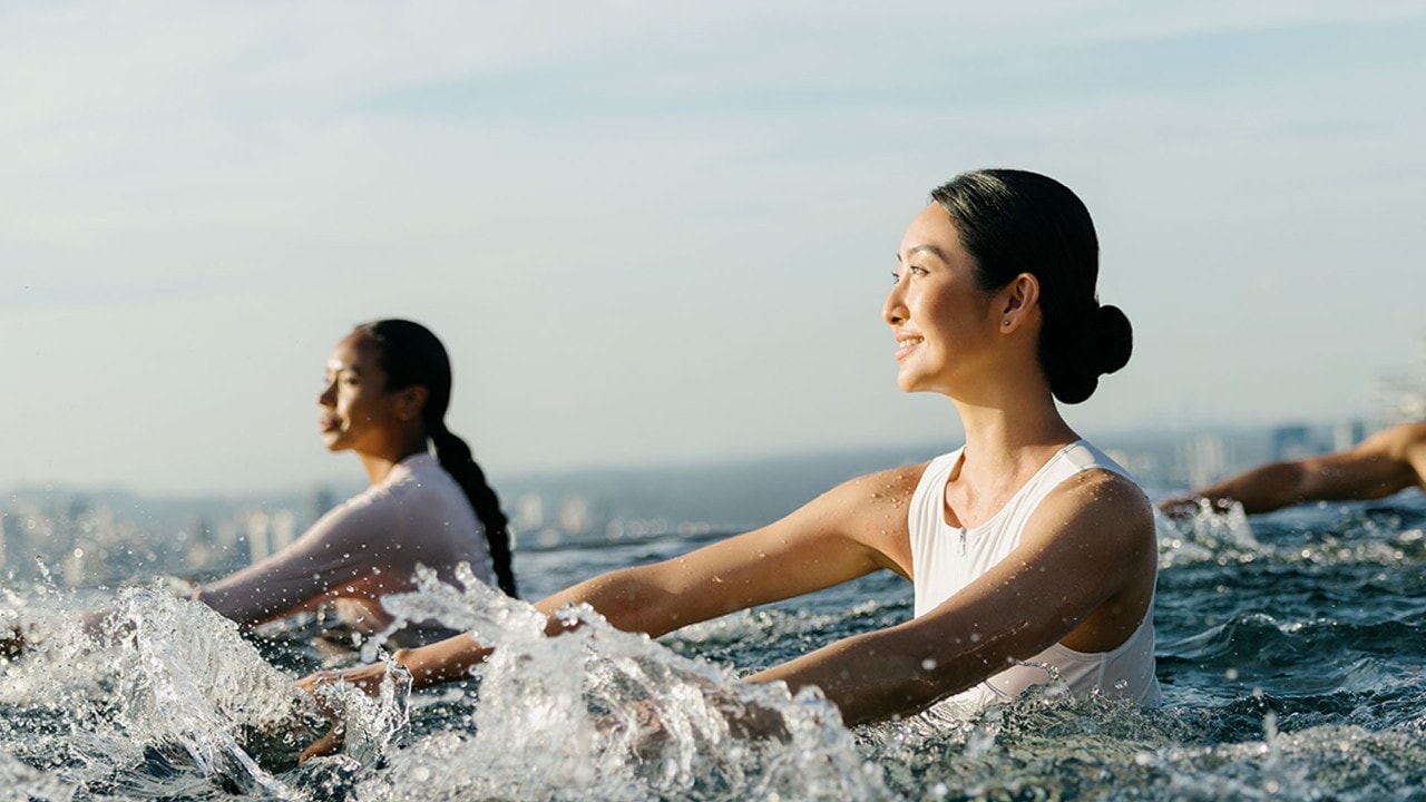 Guests working out in the Infinity Pool at Marina Bay Sands