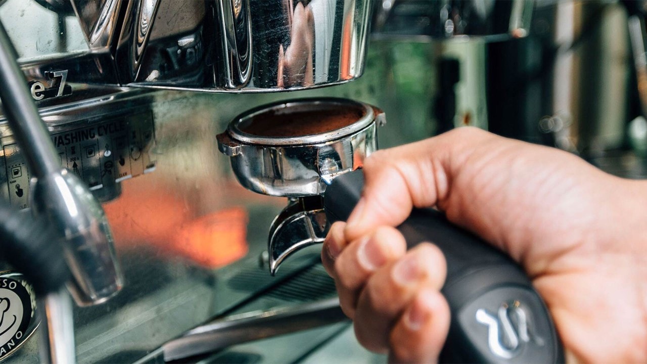 Barista preparing a cup of coffee at the best cafes at Marina Bay Sands, Singapore