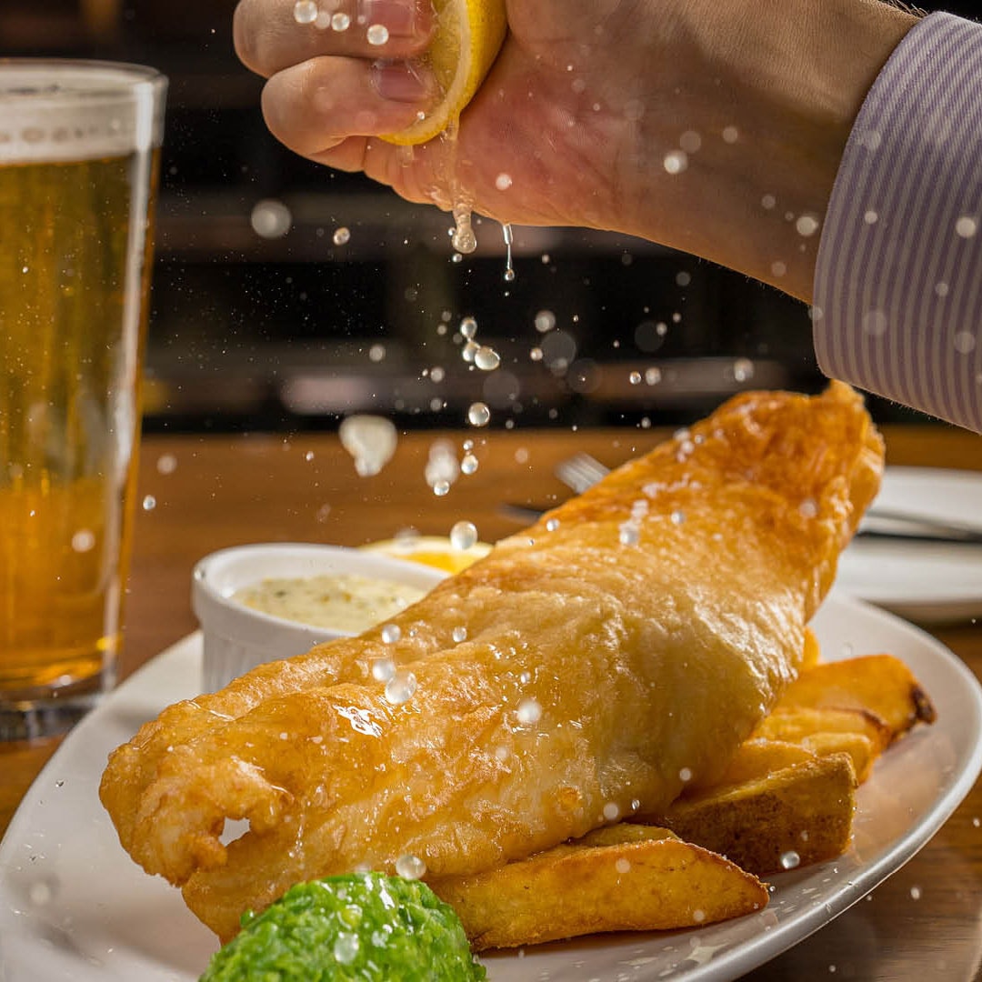 Lemon squeezed on fish and chips at a casual dining restaurant in Singapore